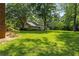 Expansive backyard featuring lush green lawn and a charming outbuilding at 186 Mt Calvary Rd, Marietta, GA 30064