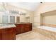 Spacious bathroom featuring a double vanity, large mirror, soaking tub and beautiful stone accents at 186 Mt Calvary Rd, Marietta, GA 30064