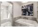 Bathroom offers a separate shower, a soaking tub, neutral tile, and built-in shelves at 186 Mt Calvary Rd, Marietta, GA 30064