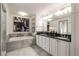 Bathroom featuring tub, shower, tile flooring, double sinks, and stylish fixtures at 186 Mt Calvary Rd, Marietta, GA 30064