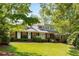 Charming brick home with a well-manicured lawn and mature trees providing shade at 186 Mt Calvary Rd, Marietta, GA 30064