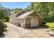 Attached three-car garage featuring stone accents, a private entrance, and a concrete driveway at 186 Mt Calvary Rd, Marietta, GA 30064