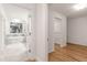 Hallway view showcasing an open door to a walk-in closet and an opening to the bathroom with tub at 186 Mt Calvary Rd, Marietta, GA 30064
