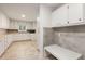 A large kitchen with lots of counter space and white cabinets, plus an adjoining area with seating at 186 Mt Calvary Rd, Marietta, GA 30064