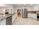 Updated kitchen boasts stainless steel appliances, white cabinets, granite counters, and tile floors at 186 Mt Calvary Rd, Marietta, GA 30064