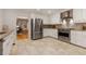 Well-lit kitchen with stainless steel appliances, granite countertops, and tiled floors at 186 Mt Calvary Rd, Marietta, GA 30064