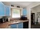 Well-organized kitchen with blue cabinets, durable countertops and modern appliances for a delightful cooking experience at 359 Dallas St, Hiram, GA 30141