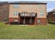 Spacious backyard with green lawn, patio, and second story deck perfect for outdoor enjoyment at 3623 Terrah Point Dr, Duluth, GA 30097