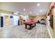 Finished basement with plank flooring, a pool table, a mini fridge, and exercise equipment at 3623 Terrah Point Dr, Duluth, GA 30097