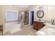 Bright bathroom featuring granite counters, tub, and separate shower at 3623 Terrah Point Dr, Duluth, GA 30097