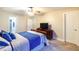 Inviting bedroom with ceiling fan, a large window, a dresser, and adjacent bathroom access for convenience and privacy at 3623 Terrah Point Dr, Duluth, GA 30097