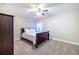 Bedroom with soft carpet, ceiling fan, and a large dark wood wardrobe at 3623 Terrah Point Dr, Duluth, GA 30097