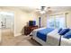 Cozy bedroom with a ceiling fan, a large window with lots of light, and a dresser with TV at 3623 Terrah Point Dr, Duluth, GA 30097