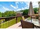 Outdoor deck featuring a dining table with umbrella, overlooking a pond and lush greenery at 3623 Terrah Point Dr, Duluth, GA 30097