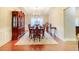 Elegant dining room with hardwood floors, a china cabinet, a chandelier, and a table set for six at 3623 Terrah Point Dr, Duluth, GA 30097