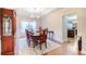 Formal dining room boasts hardwood floors, wainscoting, elegant chandelier, and ample natural light at 3623 Terrah Point Dr, Duluth, GA 30097