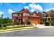 Beautiful two-story brick home with two-car garage, charming architectural details, and lush landscaping at 3623 Terrah Point Dr, Duluth, GA 30097