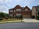 Charming two-story brick home with manicured landscaping and an attached two-car garage at 3623 Terrah Point Dr, Duluth, GA 30097