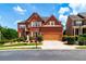 Stunning two-story brick home with a two-car garage, manicured lawn, and beautiful landscaping at 3623 Terrah Point Dr, Duluth, GA 30097