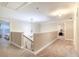 Upstairs hallway with neutral paint and carpet, featuring a decorative chandelier at 3623 Terrah Point Dr, Duluth, GA 30097