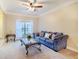 Comfortable living room featuring a sofa, a glass top coffee table, and natural light from the window at 3623 Terrah Point Dr, Duluth, GA 30097