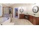 Bright main bathroom featuring a soaking tub, a glass shower, and dual vanity sinks with granite countertops at 3623 Terrah Point Dr, Duluth, GA 30097