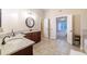 Well-lit bathroom with dual sinks, granite countertops, and doorway to the adjoining main bedroom at 3623 Terrah Point Dr, Duluth, GA 30097