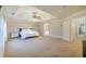 Bright main bedroom featuring a tray ceiling, ceiling fan, and doorway to the en-suite bath at 3623 Terrah Point Dr, Duluth, GA 30097