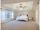Spacious main bedroom with tray ceiling, fan, large window, and neutral carpet at 3623 Terrah Point Dr, Duluth, GA 30097