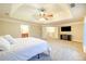 Expansive main bedroom offering tray ceiling, ceiling fan, television, and access to en-suite bathroom at 3623 Terrah Point Dr, Duluth, GA 30097