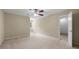 Large bedroom with neutral carpet, a ceiling fan, and an open doorway at 6553 Parkside Way, Tucker, GA 30084