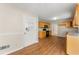 Cozy kitchen featuring natural wood cabinets, black appliances, and access to additional rooms at 6553 Parkside Way, Tucker, GA 30084