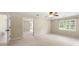 Spacious bedroom with a ceiling fan, en-suite bathroom, and open doorway to connecting rooms at 6553 Parkside Way, Tucker, GA 30084