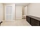 Spacious basement area with neutral carpeting, bi-fold doors, and dark dresser at 6890 Autumn Hills Dr, Cumming, GA 30028