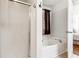 Well-lit bathroom featuring a tub with shower combination at 6890 Autumn Hills Dr, Cumming, GA 30028