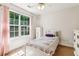 Charming bedroom with large window and natural light at 6890 Autumn Hills Dr, Cumming, GA 30028