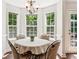 Bright breakfast nook featuring large windows and a charming chandelier at 6890 Autumn Hills Dr, Cumming, GA 30028