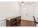 Entryway featuring wood floors, wainscoting, and a decorative console table at 6890 Autumn Hills Dr, Cumming, GA 30028