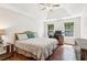 Main bedroom with a tray ceiling and ample natural light at 6890 Autumn Hills Dr, Cumming, GA 30028