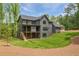 Expansive backyard featuring a modern home design, multi-level decks, and lush landscaping at 130 Nova Ln, Roswell, GA 30075