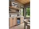 A modern bar area offers floating shelves, cabinets, and a wine fridge at 130 Nova Ln, Roswell, GA 30075