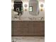 Close up of the bathroom vanity boasting dual sinks, marble countertops and unique lighting at 130 Nova Ln, Roswell, GA 30075