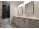 Bathroom featuring double vanity, marble countertop and tile, and stylish mirrors at 130 Nova Ln, Roswell, GA 30075