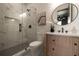 Modern bathroom featuring a glass-enclosed shower, marble tile, and stylish vanity at 130 Nova Ln, Roswell, GA 30075