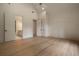 Bedroom showcasing hardwood floors, high ceilings, and an adjoining bathroom and closet at 130 Nova Ln, Roswell, GA 30075