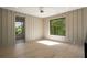 Bright bedroom with light wood floors, paneled accent wall, and large windows at 130 Nova Ln, Roswell, GA 30075