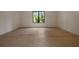 Bedroom showing a hardwood floor and a large window bringing in natural light at 130 Nova Ln, Roswell, GA 30075