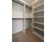 Spacious walk-in closet with custom shelving and hardwood floors at 130 Nova Ln, Roswell, GA 30075