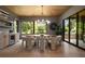 Dining room featuring stylish lighting and a large window with views of the outdoor landscape at 130 Nova Ln, Roswell, GA 30075