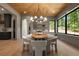 Dining area featuring stylish lighting and a large window with views of the outdoor landscape at 130 Nova Ln, Roswell, GA 30075